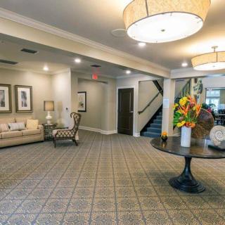 A well-appointed lobby area with comfortable seating, stylish decor, and a floral arrangement on a central table.