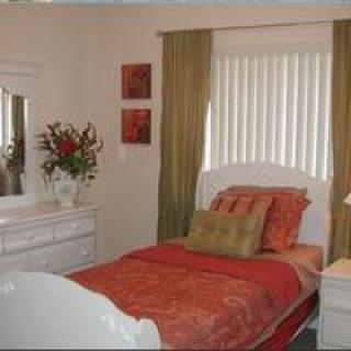 A cozy bedroom with a single bed and elegant decor.