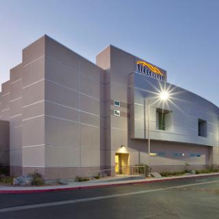 A modern building illuminated at dusk, showcasing contemporary architectural design.