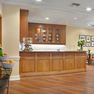 A warm and inviting kitchen with wooden cabinetry and a cozy dining space.