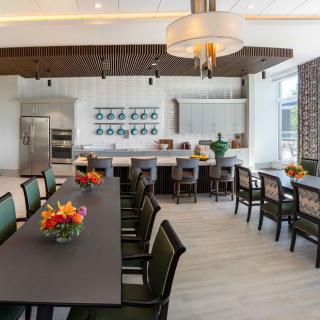 A modern open kitchen and dining area with elegant decor and wooden flooring.