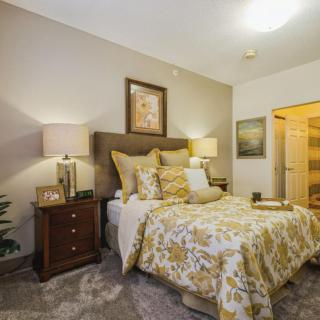 A cozy bedroom with elegant decor and warm lighting.