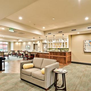 A modern lounge with a comfortable seating area and bar.