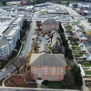 Aerial view of a residential complex surrounded by urban infrastructure.