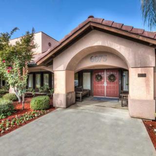 A welcoming entrance to a residential building with landscaped surroundings.