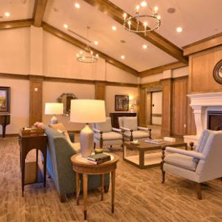 A cozy living room featuring traditional furniture, warm lighting, and a welcoming fireplace.