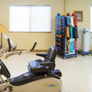 A fitness room equipped with exercise machines and various workout accessories.