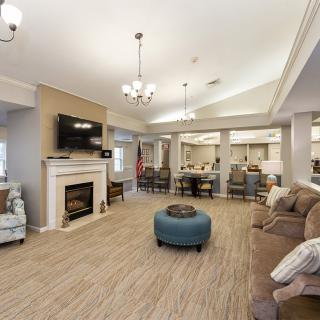 A cozy living room with a fireplace, television, and comfortable seating.