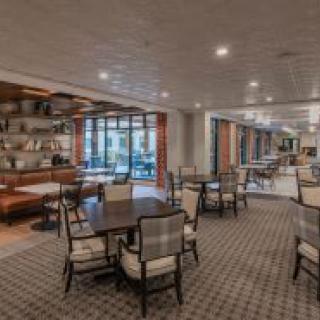 A modern restaurant dining area with neatly arranged tables and chairs.