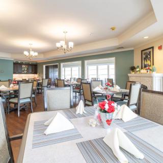 A well-lit dining room with neatly arranged tables and elegant decor.