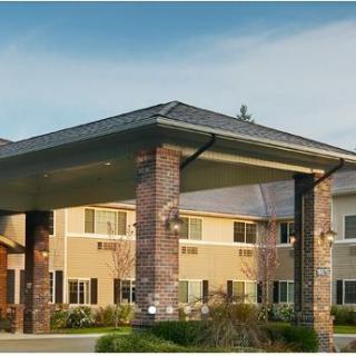 A modern residential building with a covered front entrance.