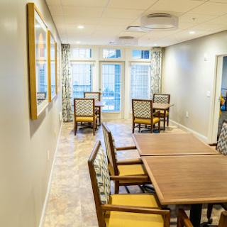 A spacious and inviting dining area with wooden tables and comfortable chairs, perfect for social gatherings.