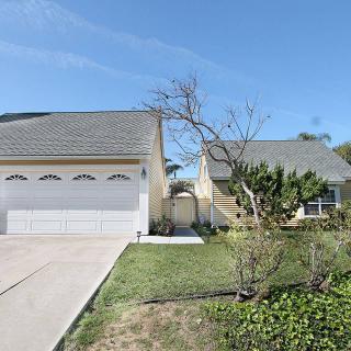 A suburban house with a two-car garage and a well-maintained front yard.