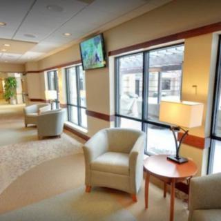 A modern lobby with comfortable seating and large windows.