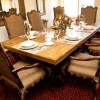 A beautifully set dining table with elegant chairs in a traditional dining room.