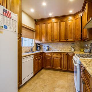 A cozy kitchen with wooden cabinets and modern appliances.