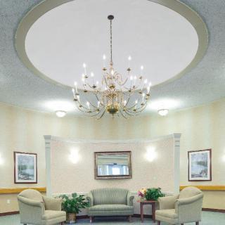 Elegant lobby with a chandelier and comfortable seating.