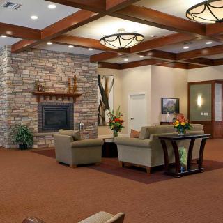 A modern lobby with a cozy seating area and stone fireplace.