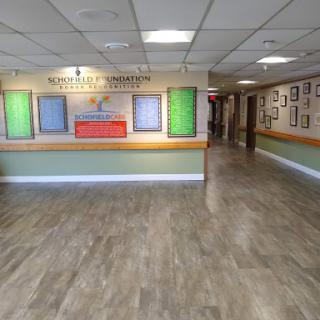 A spacious and modern lobby area featuring colorful wall displays and a reception desk.