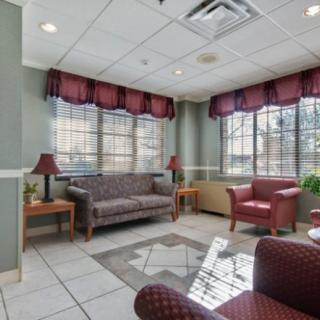 A cozy waiting room with comfortable seating and large windows.