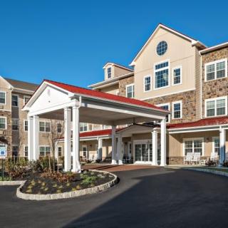 A residential building with a prominent entrance and well-maintained landscaping.