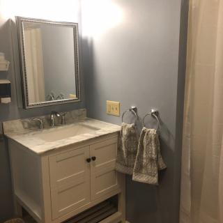 A cozy bathroom with a modern vanity and neatly hung towels.