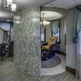 A modern spa interior featuring a massage chair in a relaxation area.