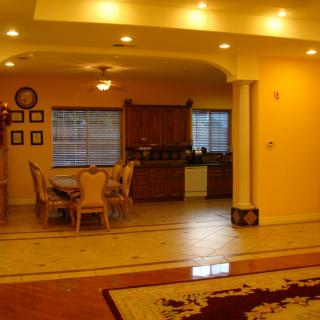 A spacious open-plan kitchen and dining area with warm lighting and elegant furnishings.