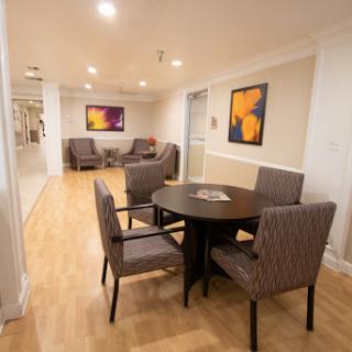 A modern seating area in a lobby featuring stylish furniture and colorful artwork.