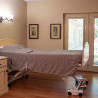 A well-furnished hospital room with a comfortable hospital bed and soothing decor.