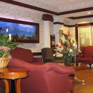 A cozy lobby with comfortable seating and floral decorations.