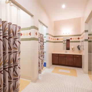 A beautifully designed modern bathroom featuring elegant tiles and a spacious vanity area.