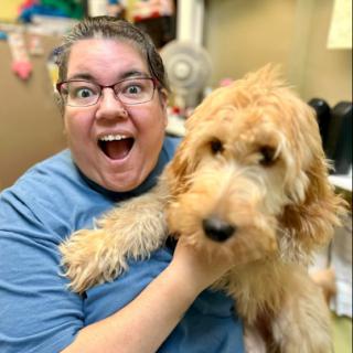 A joyful moment shared between a person and a fluffy dog.