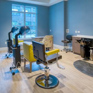 A modern hair salon interior with styling chairs and hairdressing equipment.
