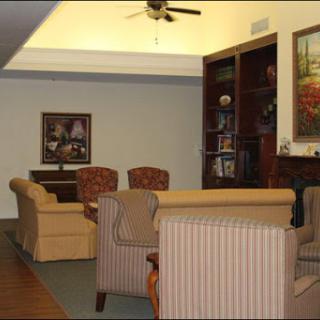 A cozy living room featuring comfortable seating and a bookshelf, perfect for relaxation and socializing.