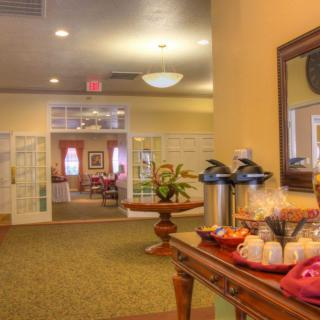 A warm and inviting lobby area featuring a coffee station and comfortable seating.