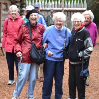 A group of seniors enjoying a day outdoors, sharing laughter and companionship.