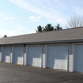 A row of garage storage units with closed doors.