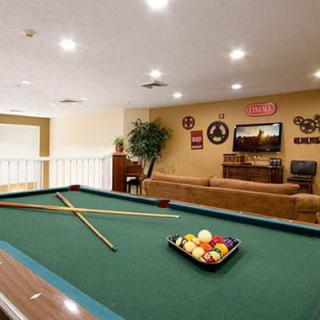 A cozy recreation room featuring a pool table, comfortable seating, and stylish decor.