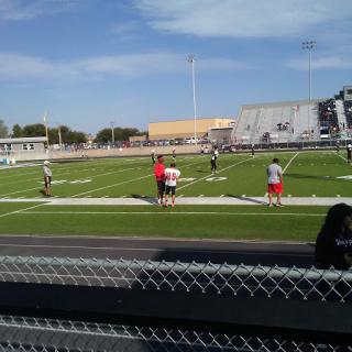 A group of people participating in training activities on a football field.