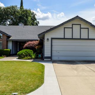 A suburban house with a two-car garage and well-maintained lawn.