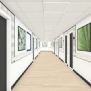A minimalist hallway adorned with framed artwork on its white walls.