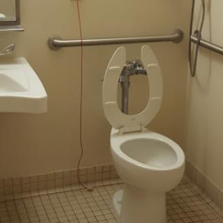 A clean and accessible bathroom featuring a toilet and sink.