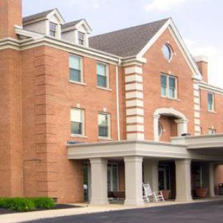 A brick building with a prominent entrance, likely a hotel.