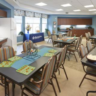 An inviting dining and meeting area with multiple tables and chairs arranged for a casual gathering.