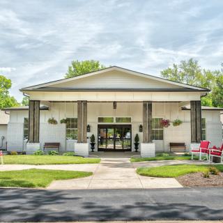 A well-maintained building with a welcoming entrance surrounded by greenery.