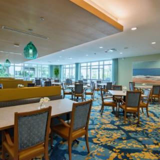 A spacious and modern restaurant dining area with tables and chairs arranged neatly.