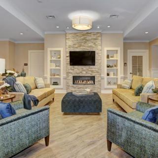 A modern living room with a cozy fireplace and comfortable seating.