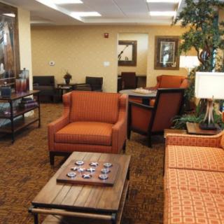 A cozy living room lounge with comfortable seating and warm lighting.