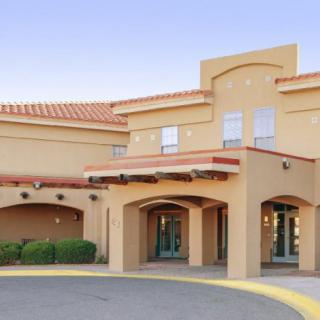 A desert-style building with an arched entrance and terracotta roof.